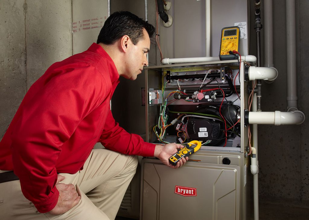 HVAC technician repairing an indoor furnace in Loveland