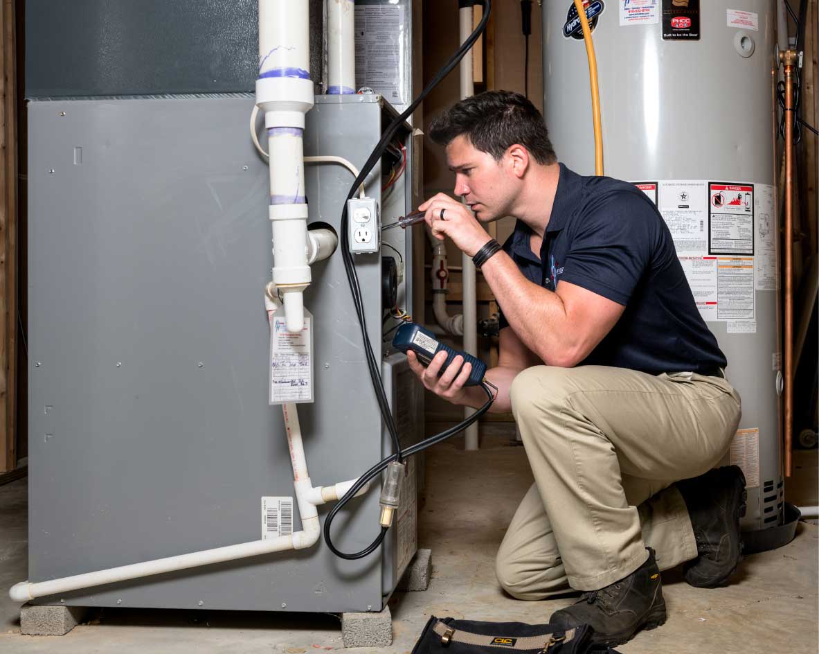 HVAC technician performing a furnace tune-up in Loveland