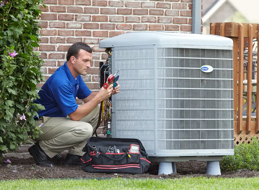 HVAC technician inspecting an outdoor air conditioning unit in Loveland