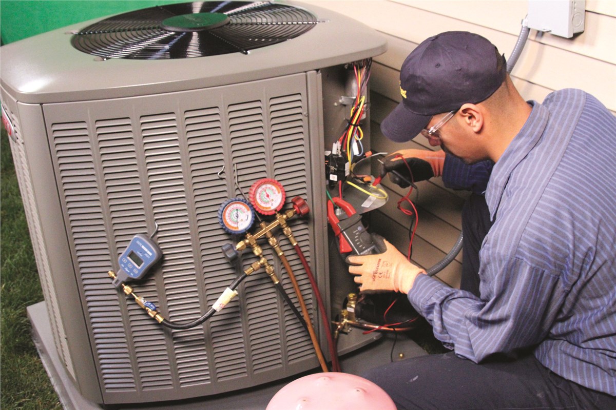 HVAC technician testing an outdoor air conditioning unit in Loveland